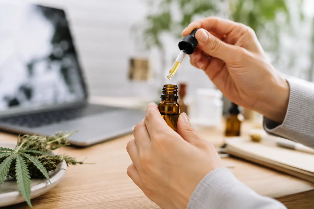 Gros plan sur un certificat d'analyse laboratoire posé à côté de flacons d'huile CBD